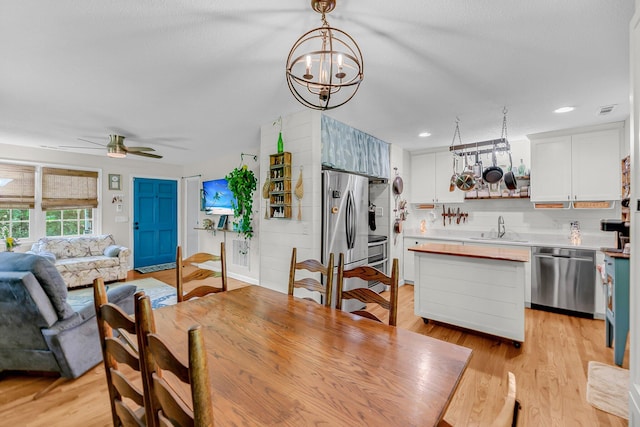 7274 Commodore Rd, Hollywood, SC 29449 - dining room with a ceiling fan, light wood-type flooring, and a chandelier