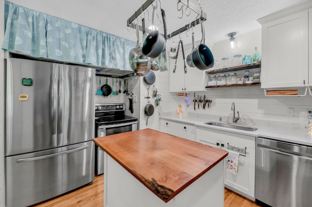 7274 Commodore Rd, Hollywood, SC 29449 - kitchen featuring appliances with stainless steel finishes, wood counters, light wood-style flooring, and a center island
