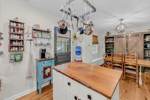 7274 Commodore Rd, Hollywood, SC 29449 - kitchen featuring butcher block counters, light wood-style floors, white cabinetry, and a center island