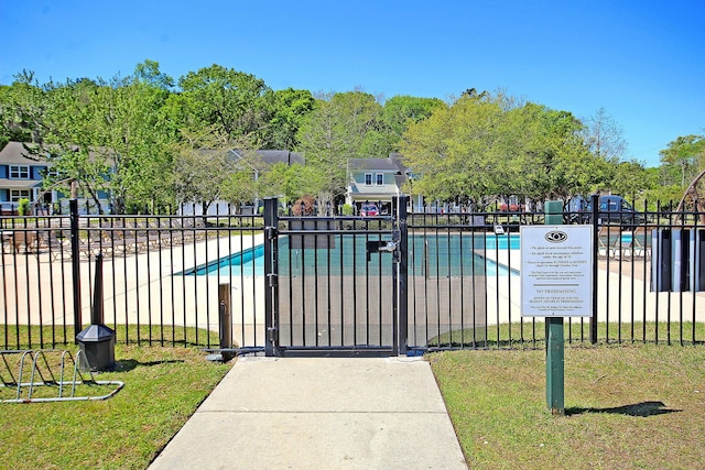 view of swimming pool featuring a lawn