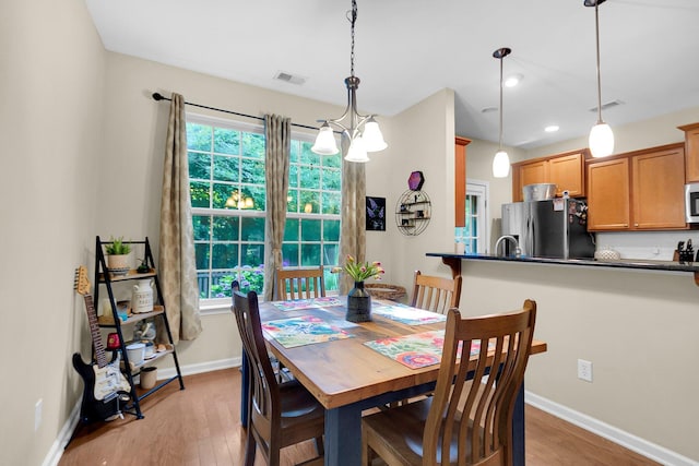 dining space featuring plenty of natural light and light wood-type flooring