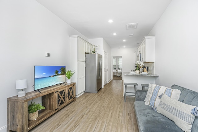 living room with light hardwood / wood-style flooring