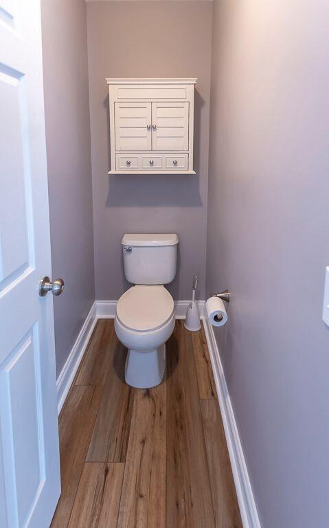 bathroom with hardwood / wood-style floors and toilet