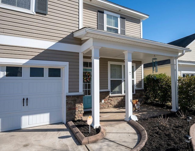 view of exterior entry featuring covered porch