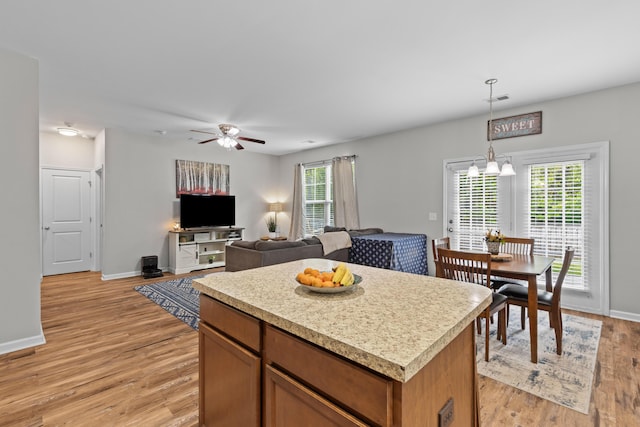 kitchen with visible vents, light countertops, light wood-style floors, and baseboards
