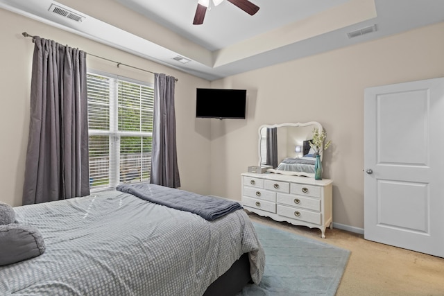 bedroom with light carpet, ceiling fan, baseboards, and visible vents