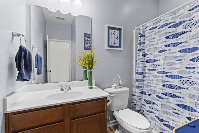 bathroom featuring vanity, visible vents, and toilet