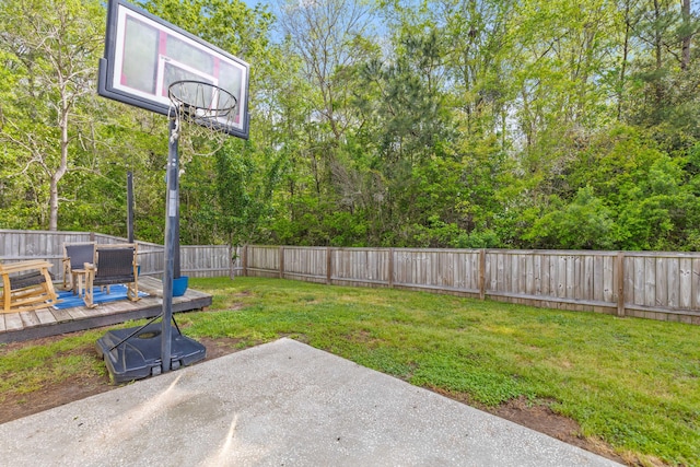 view of yard with a patio area, a deck, and a fenced backyard
