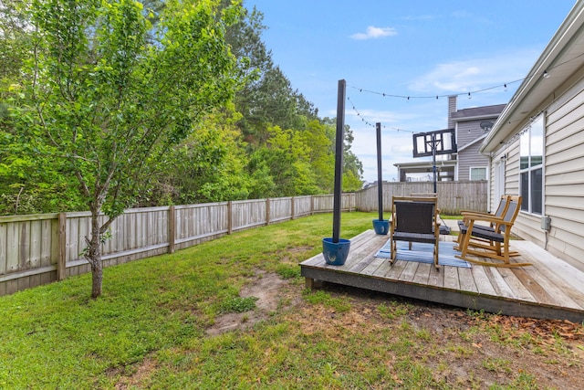 view of yard with a fenced backyard and a deck