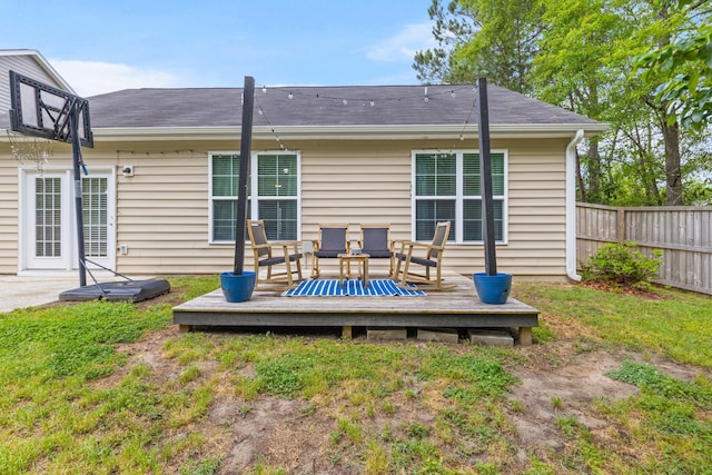 back of house with a yard, a deck, and fence