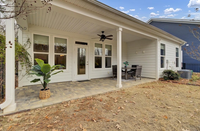 doorway to property with a patio area, ceiling fan, and central AC unit