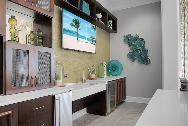 bathroom with tile patterned flooring, ornamental molding, and wine cooler