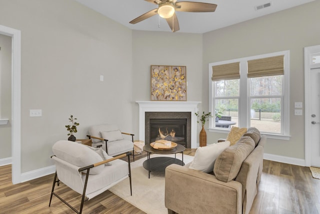 living room with ceiling fan and hardwood / wood-style floors