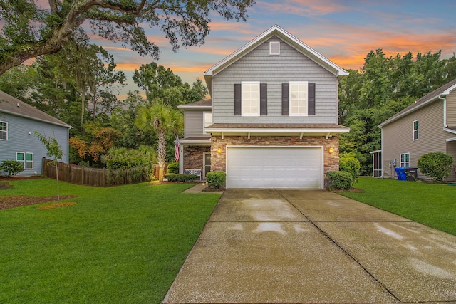 view of property with a lawn and a garage