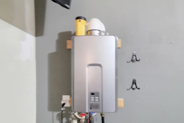 utility room featuring water heater