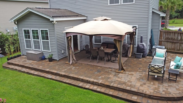 rear view of property with a gazebo and a patio area