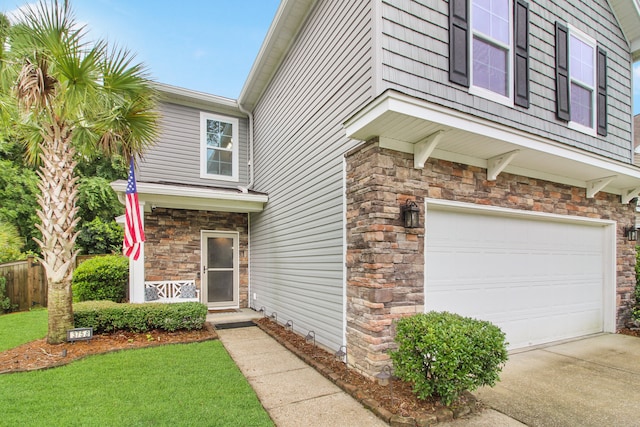 exterior space with a garage and a front lawn