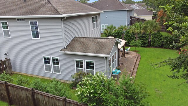 rear view of property with a yard