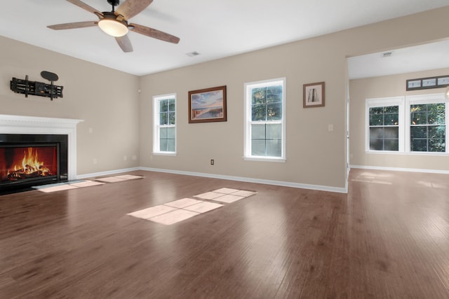 unfurnished living room featuring ceiling fan and hardwood / wood-style floors