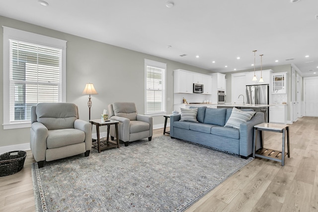 living room featuring light hardwood / wood-style flooring and sink