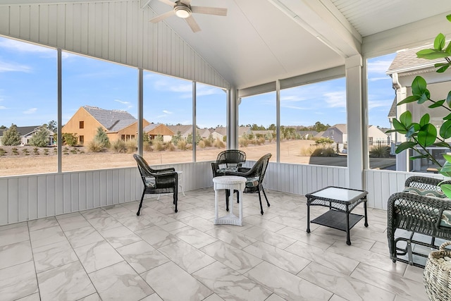 sunroom featuring ceiling fan and lofted ceiling