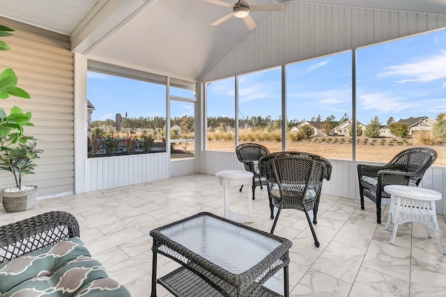 sunroom / solarium featuring ceiling fan and lofted ceiling