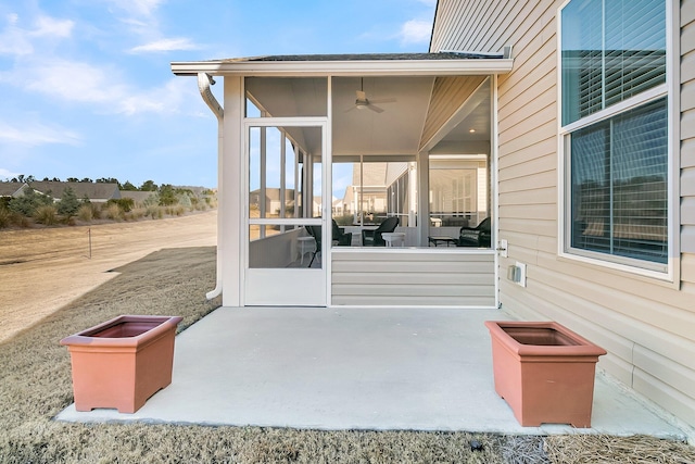 view of patio featuring a sunroom and ceiling fan