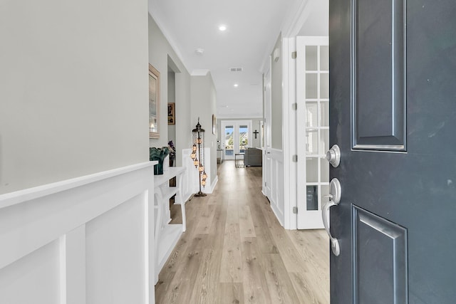 foyer entrance featuring french doors and light wood-type flooring