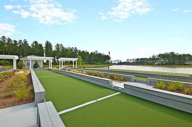 view of property's community with a pergola and a water view