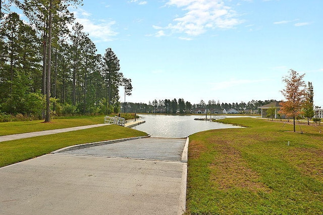 surrounding community with a yard and a water view