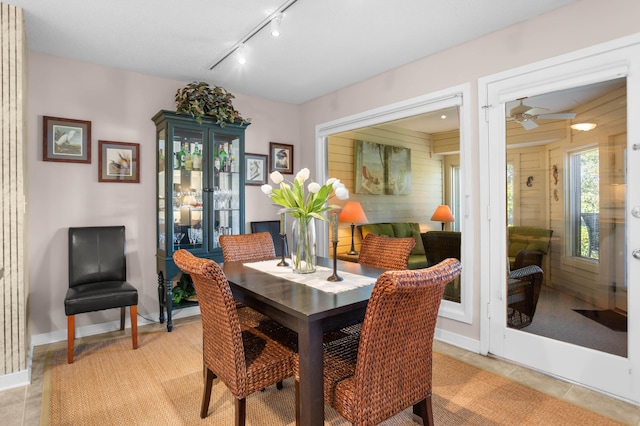 dining space featuring light tile patterned floors and rail lighting