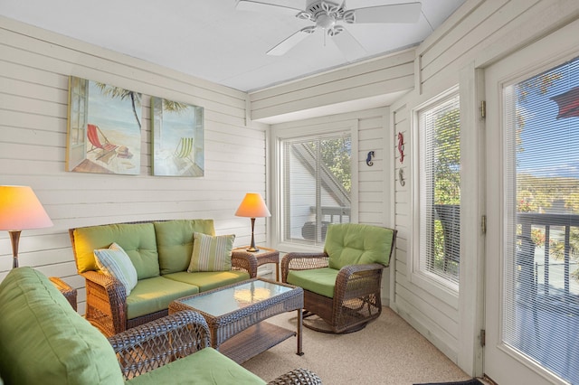 sunroom / solarium featuring ceiling fan