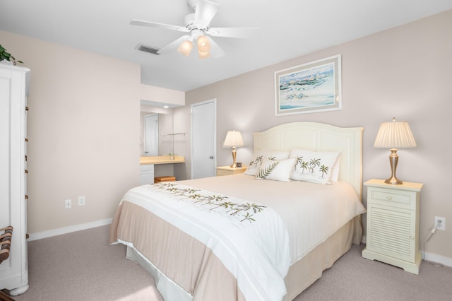 bedroom featuring visible vents, light carpet, baseboards, and ensuite bathroom