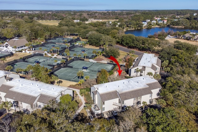 drone / aerial view with a residential view, a forest view, and a water view