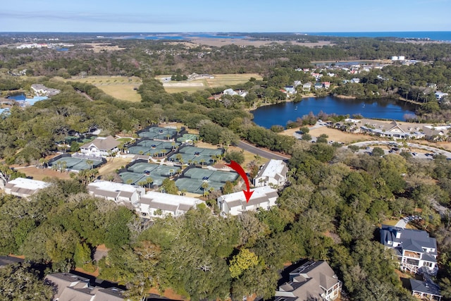 aerial view with a residential view, a water view, and a view of trees