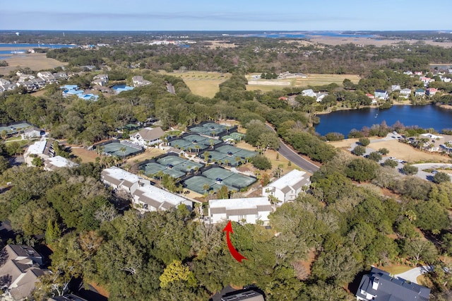 birds eye view of property with a residential view, a water view, and a wooded view