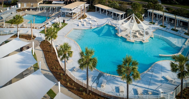 community pool with a patio area and a pergola