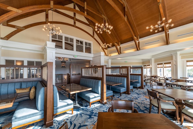 dining space featuring an inviting chandelier, wood ceiling, and high vaulted ceiling