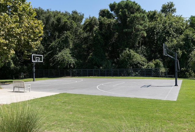 view of sport court featuring a yard, community basketball court, and fence