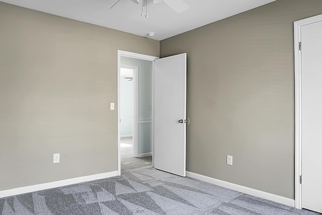 unfurnished room featuring ceiling fan, baseboards, and light colored carpet