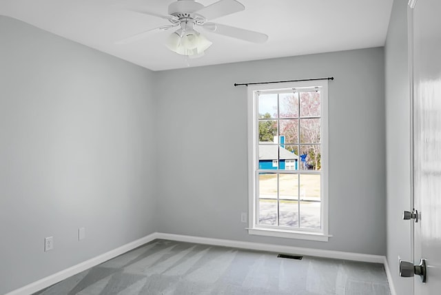 empty room featuring a ceiling fan, carpet floors, and baseboards