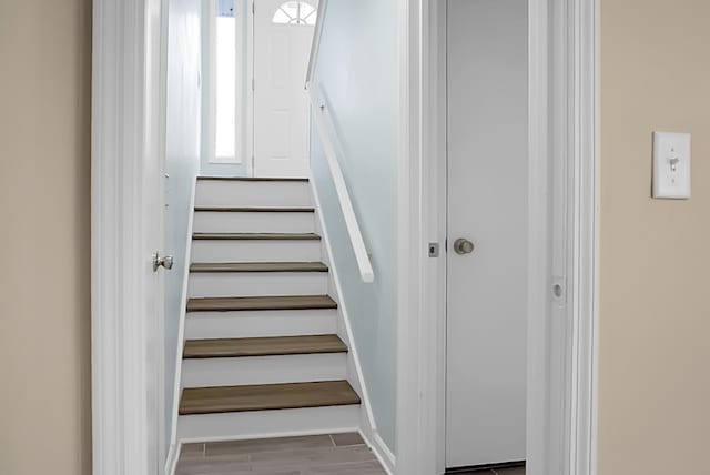 stairs with baseboards and wood finished floors