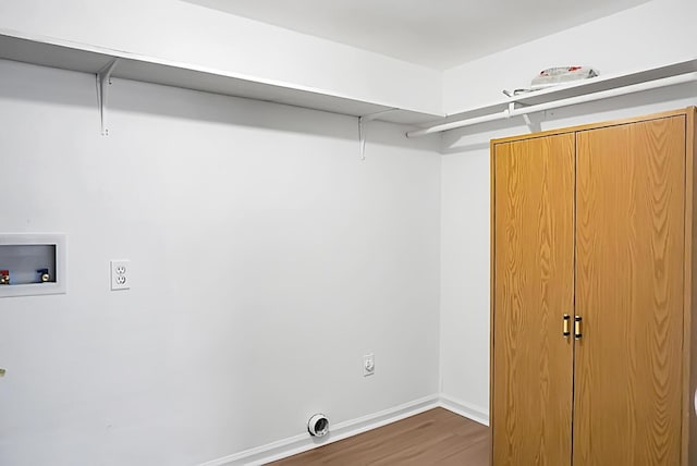 clothes washing area with hookup for a washing machine, hookup for an electric dryer, wood finished floors, laundry area, and baseboards