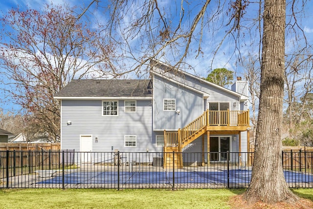 rear view of house with fence, a pool, stairs, a chimney, and a patio area