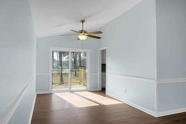 spare room featuring vaulted ceiling, ceiling fan, wood finished floors, and baseboards