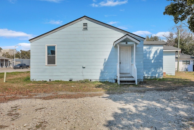 view of front facade with entry steps and crawl space