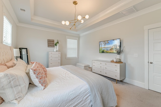 bedroom with multiple windows, light carpet, a notable chandelier, and a tray ceiling