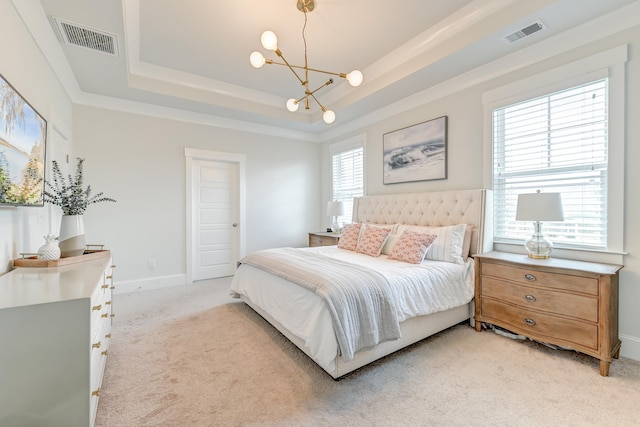 carpeted bedroom with multiple windows, an inviting chandelier, and a tray ceiling