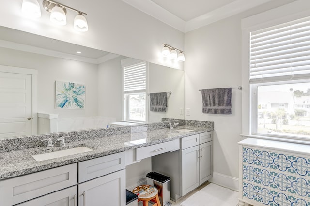 bathroom featuring crown molding and double sink vanity