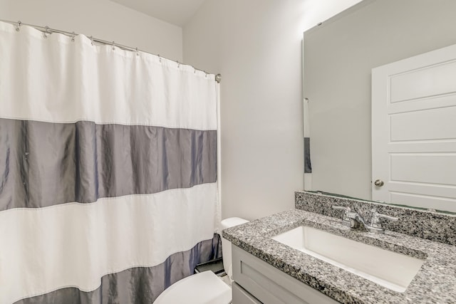 bathroom featuring toilet and large vanity